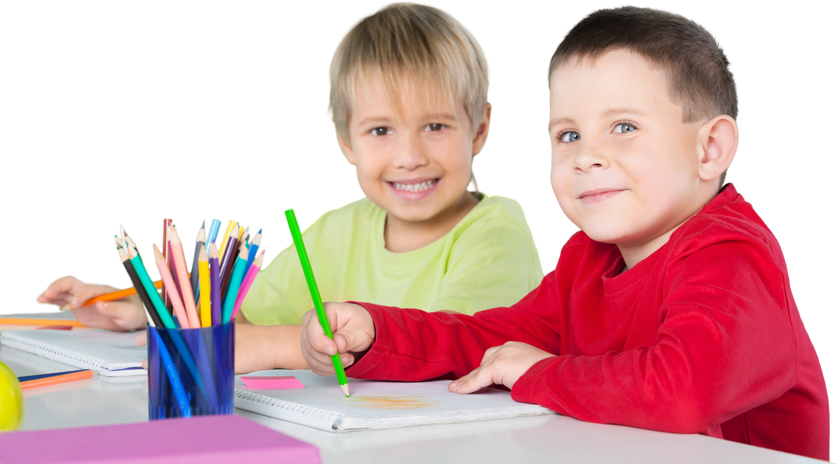 Two Smiling School Children Drawing on Notebooks